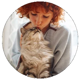 WOman giving her cat a kiss on the nose