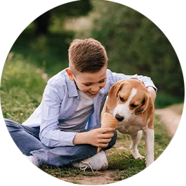 Boy cuddling his dog