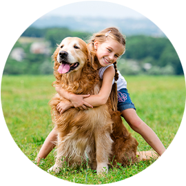 little girl hugging her dog