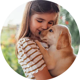 little girl cuddling with a dog